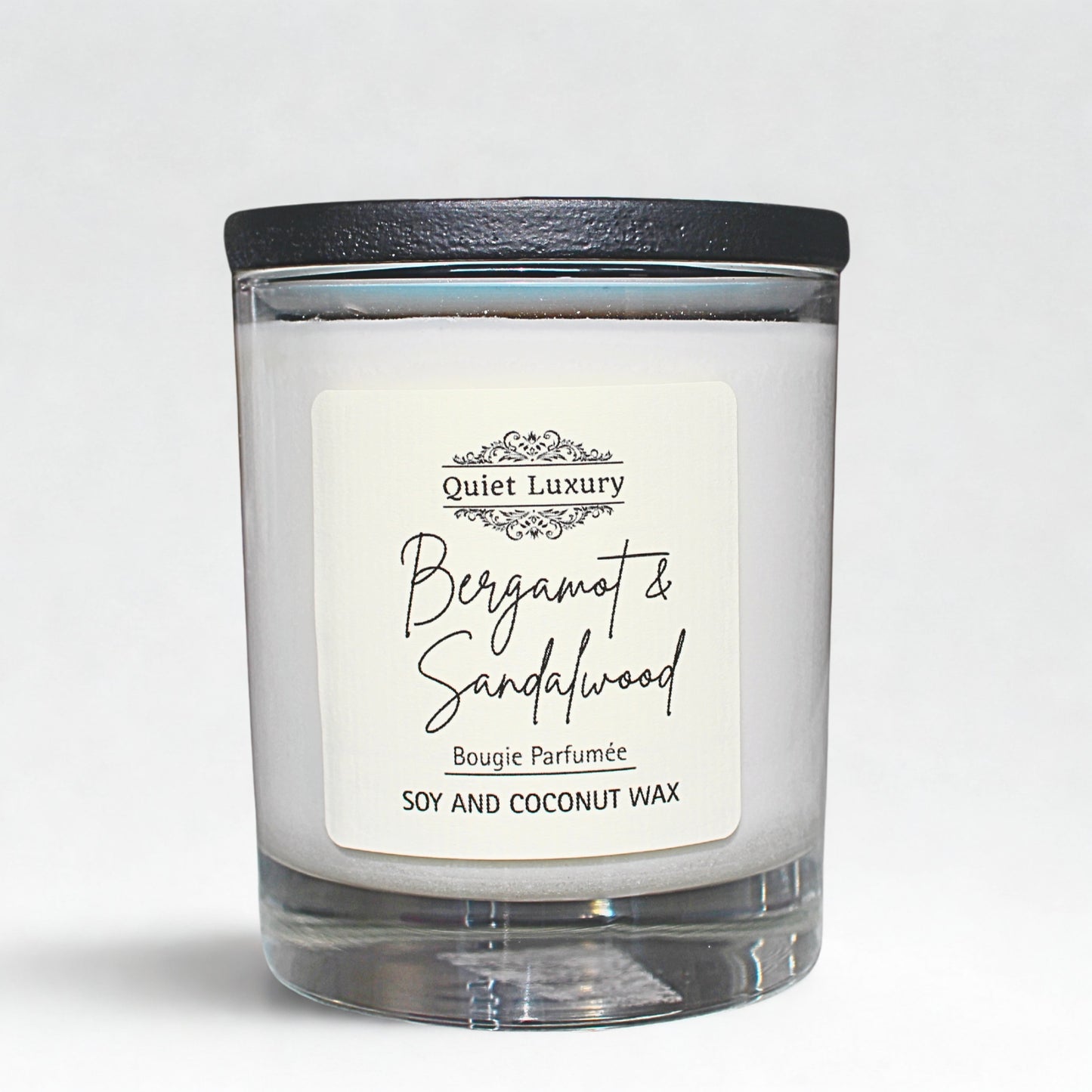 Bergamot and sandalwood Candle with a 'Quiet Luxury' label on a light gray background
