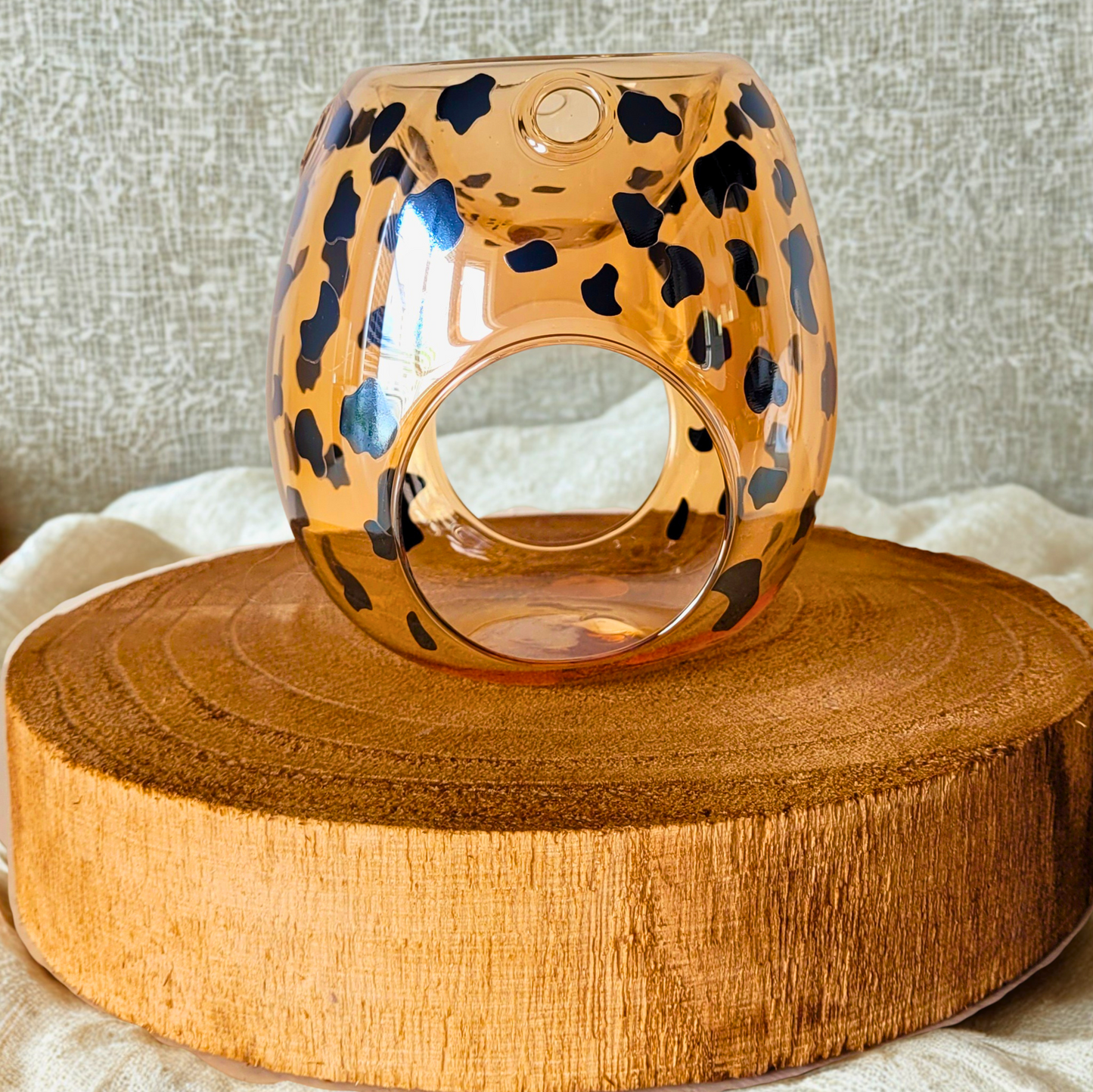 Leopard print wax warmer on a wooden surface with a neutral background