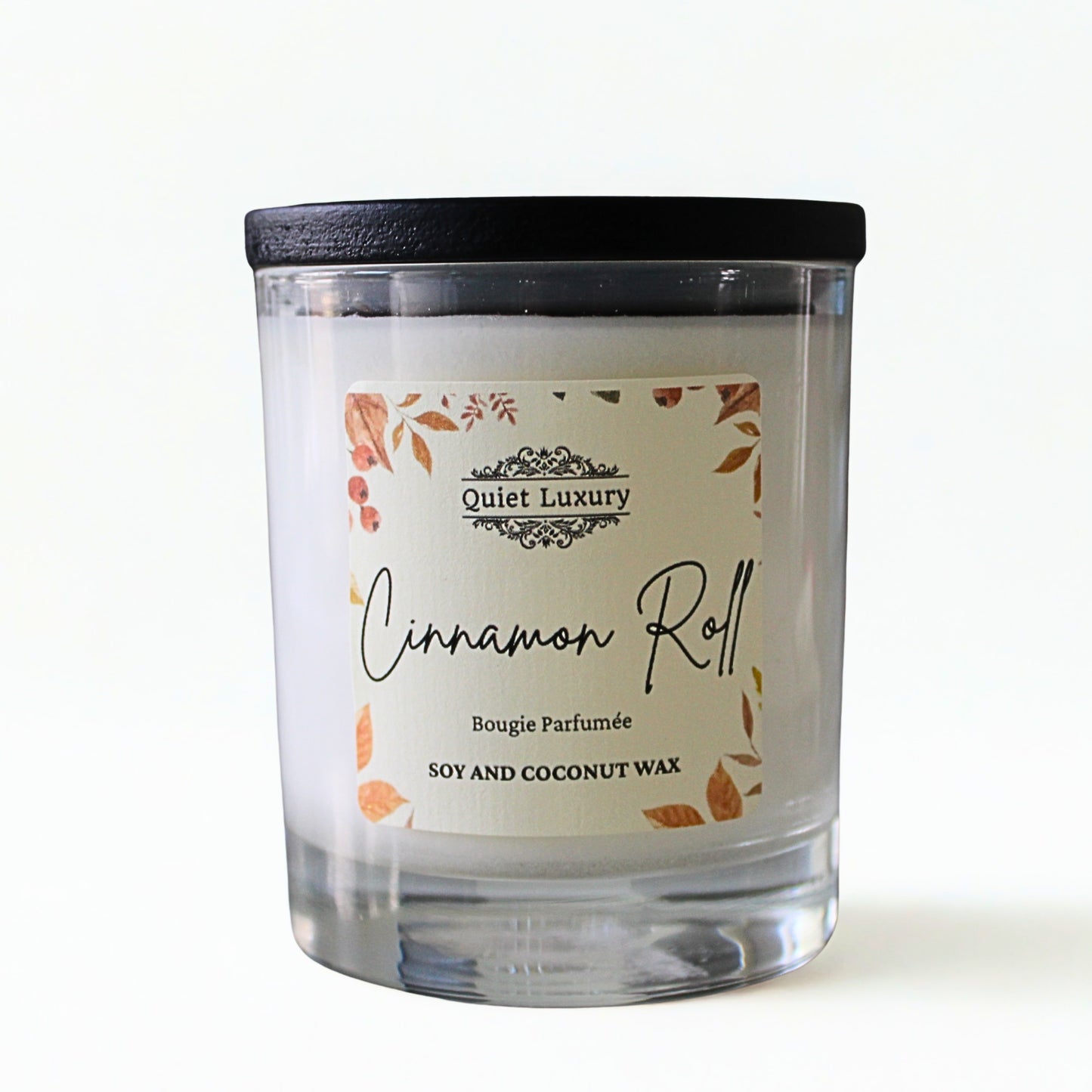 Candle labeled 'Cinnamon Roll' by 'Quiet Luxury' autumn 2025
