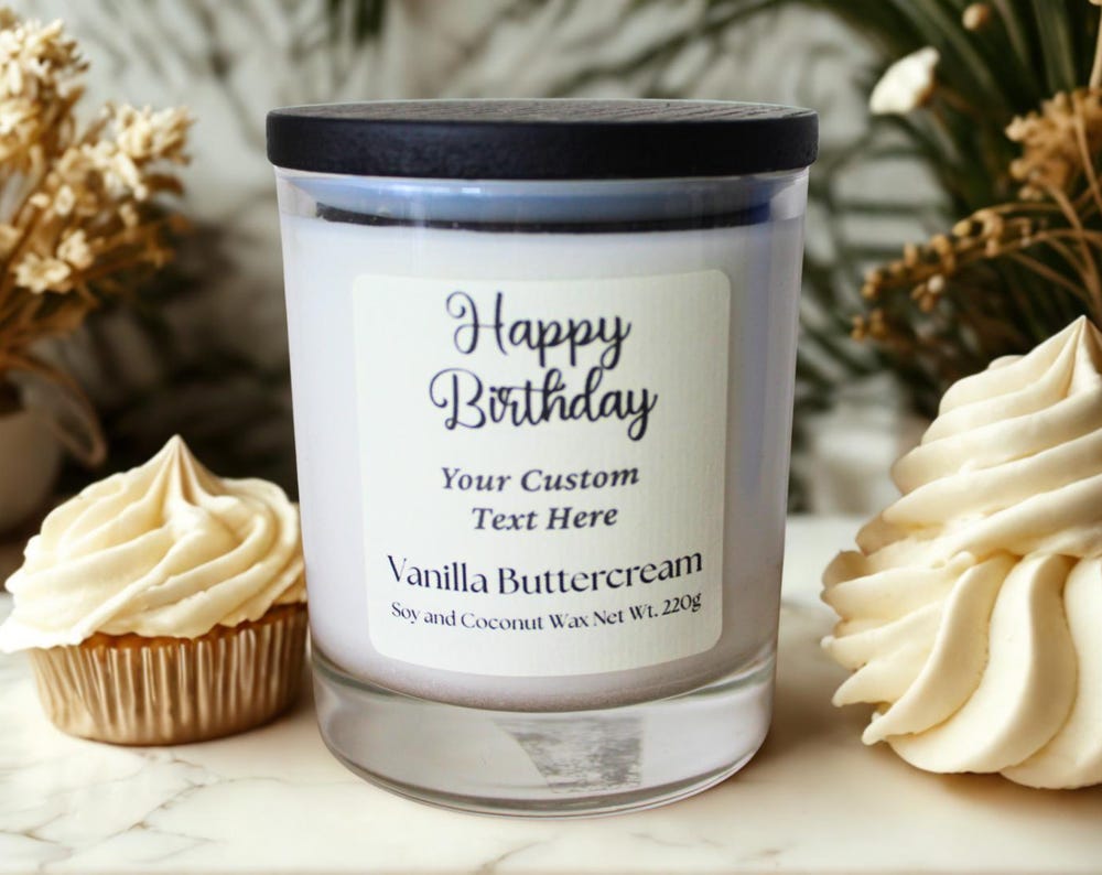 Vanilla buttercream birthday candle with custom label, surrounded by cupcakes and dried flowers