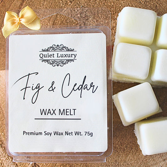 Luxury Fig & Cedar wax melt packaging with wax melts on a wooden surface