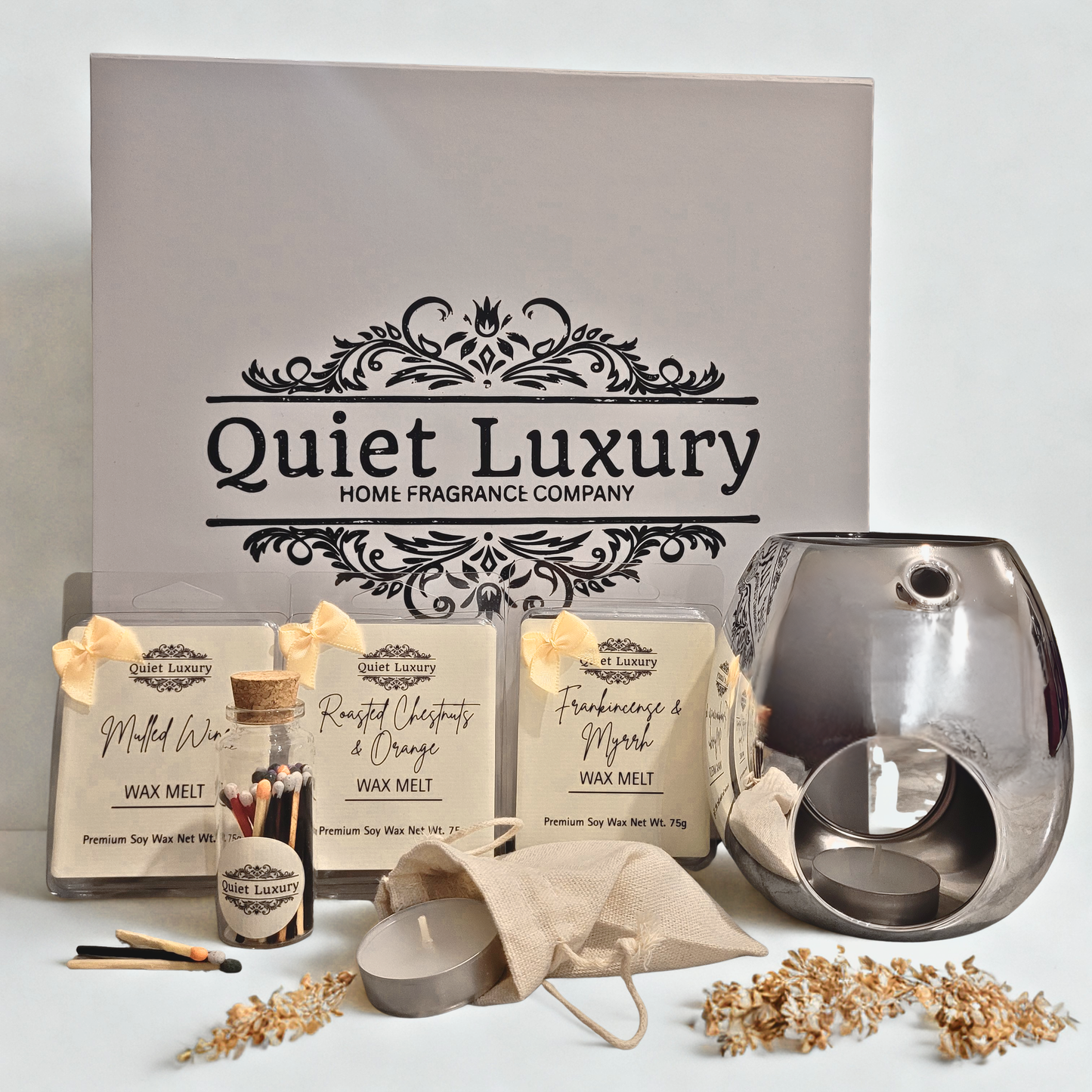 Quiet Luxury home fragrance products including wax melts and a diffuser on a light background