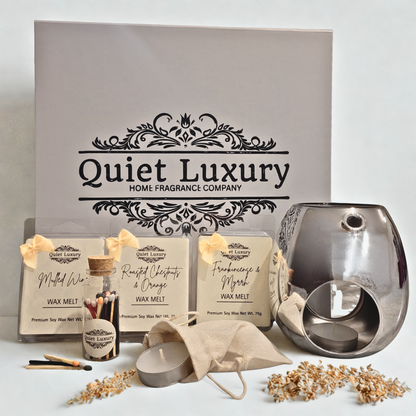 Quiet Luxury home fragrance products including wax melts and a diffuser on a light background