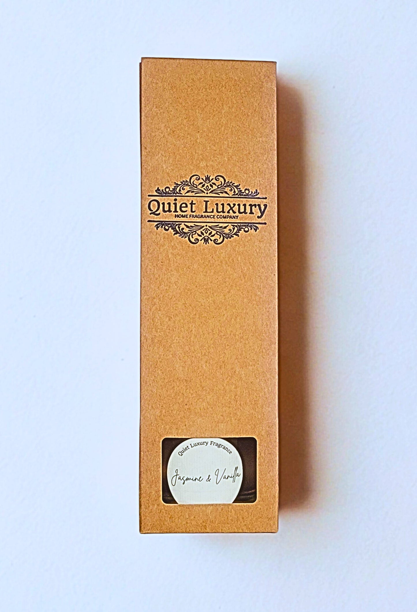 Brown packaging box with 'Quiet Luxury' branding on a light blue background