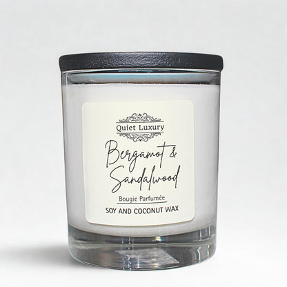 Bergamot and sandalwood scented candle in glass jar with black lid, soy and coconut wax