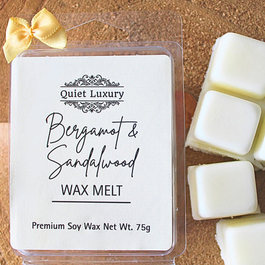 Bergamot & Sandalwood wax melt packaging with visible wax melts on a wooden surface.