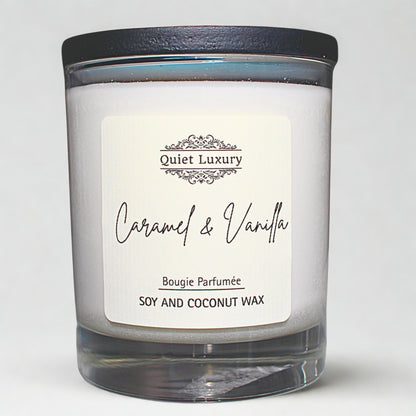 Caramel and vanilla scented soy and coconut wax candle in a glass jar with black lid