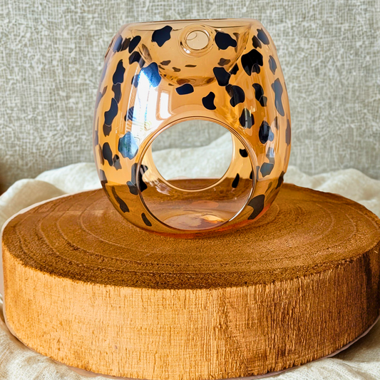 Leopard print wax warmer on a wooden surface with a neutral background