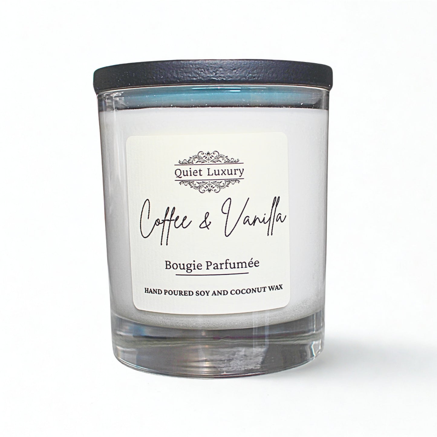 Candle with a label reading 'Coffee & Vanilla' by 'Quiet Luxury' on a white background