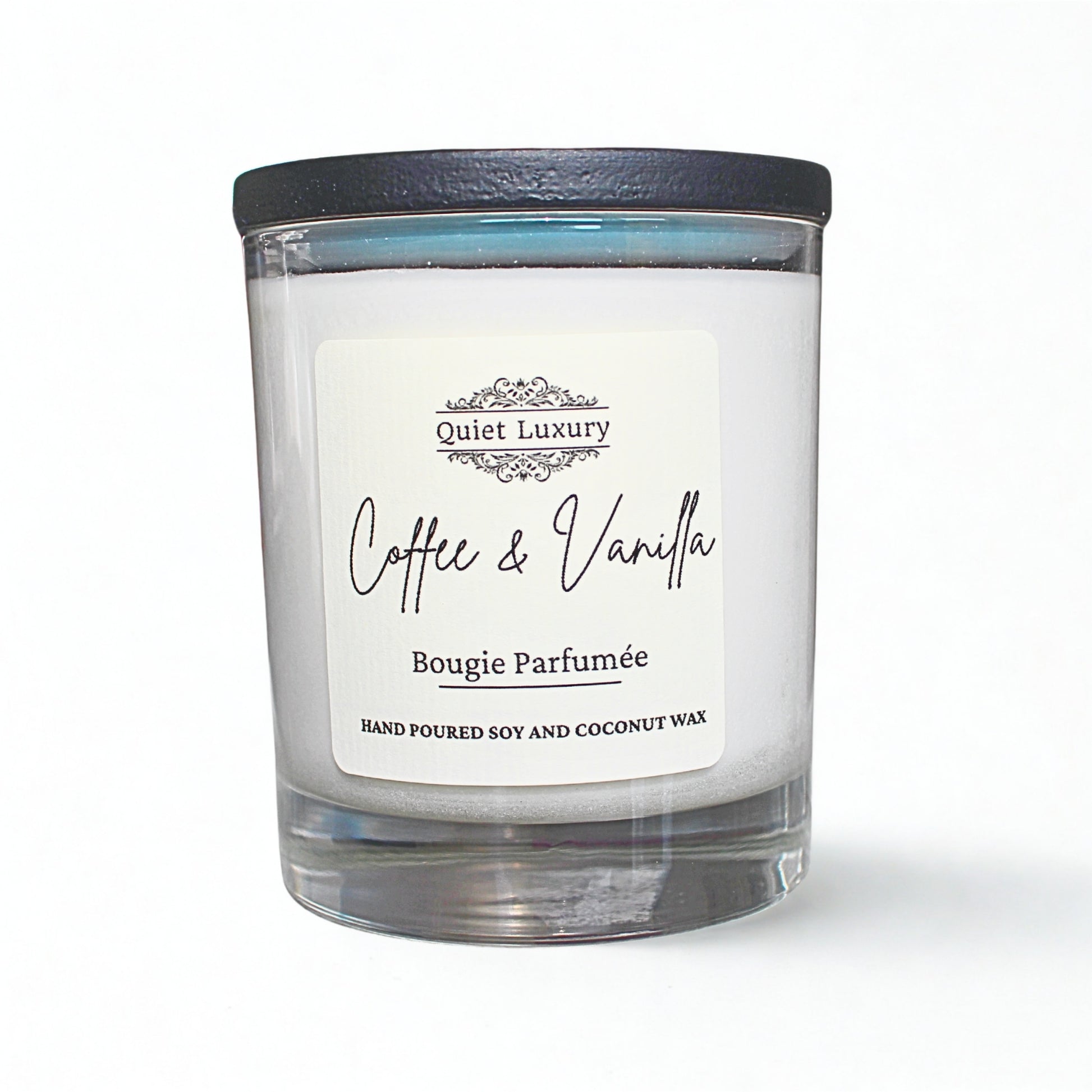 Candle with a label reading 'Coffee & Vanilla' by 'Quiet Luxury' on a white background