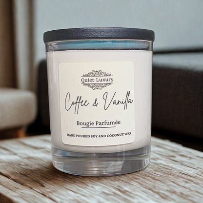 Coffee and vanilla scented soy and coconut wax candle in a glass jar on a wooden table