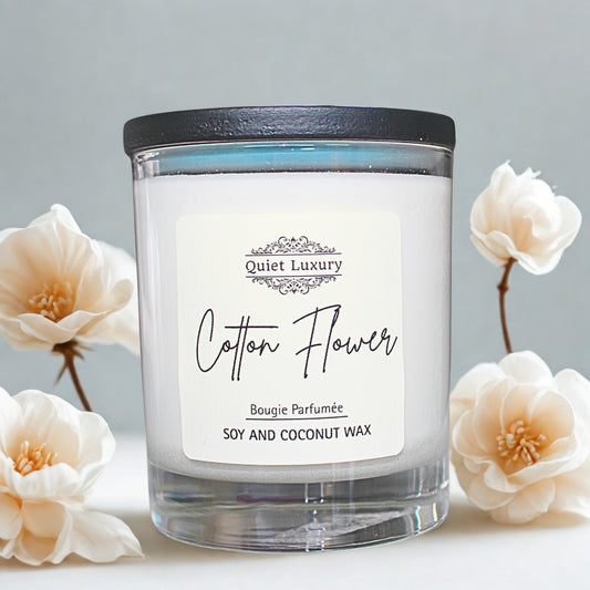Candle labeled 'Cotton Flower' with a black lid on a light background