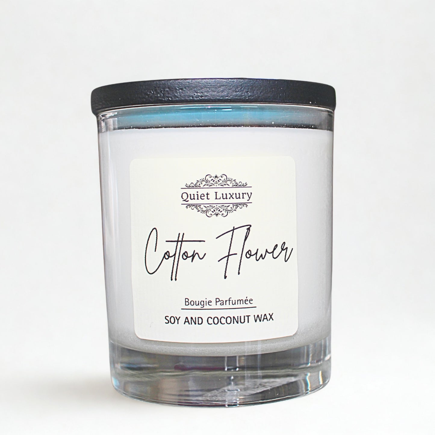 Candle with 'Cotton Flower' label on a white background