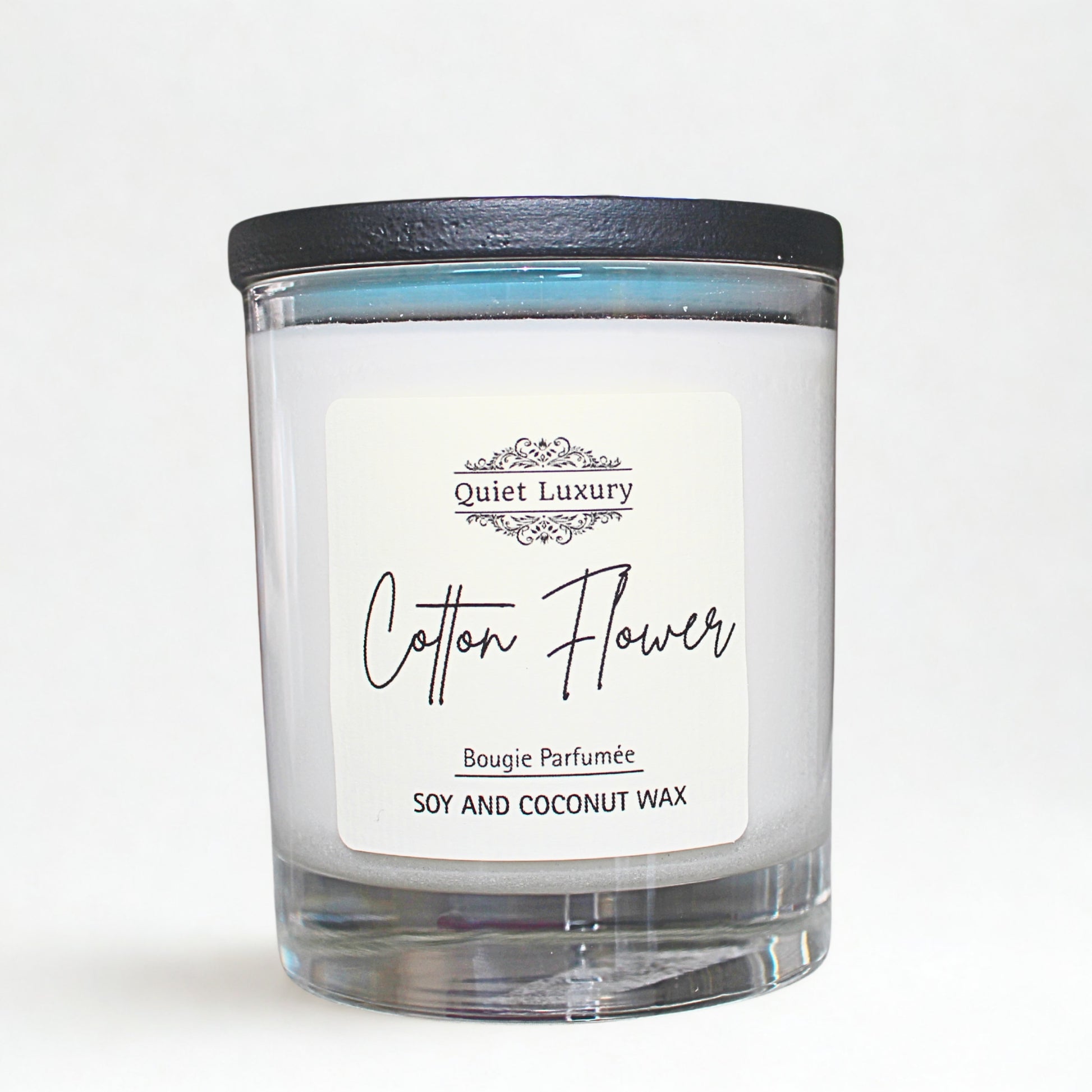 Candle with 'Cotton Flower' label on a white background