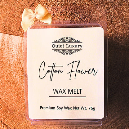 Cotton Flower wax melt with premium soy wax in clear packaging, beige ribbon, on wood surface