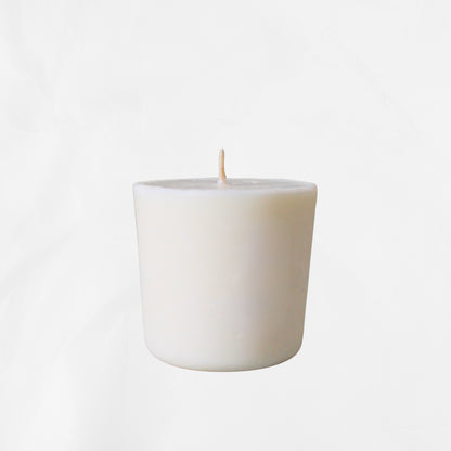Eco-friendly candle refill in white soy wax with cotton wick on a plain background