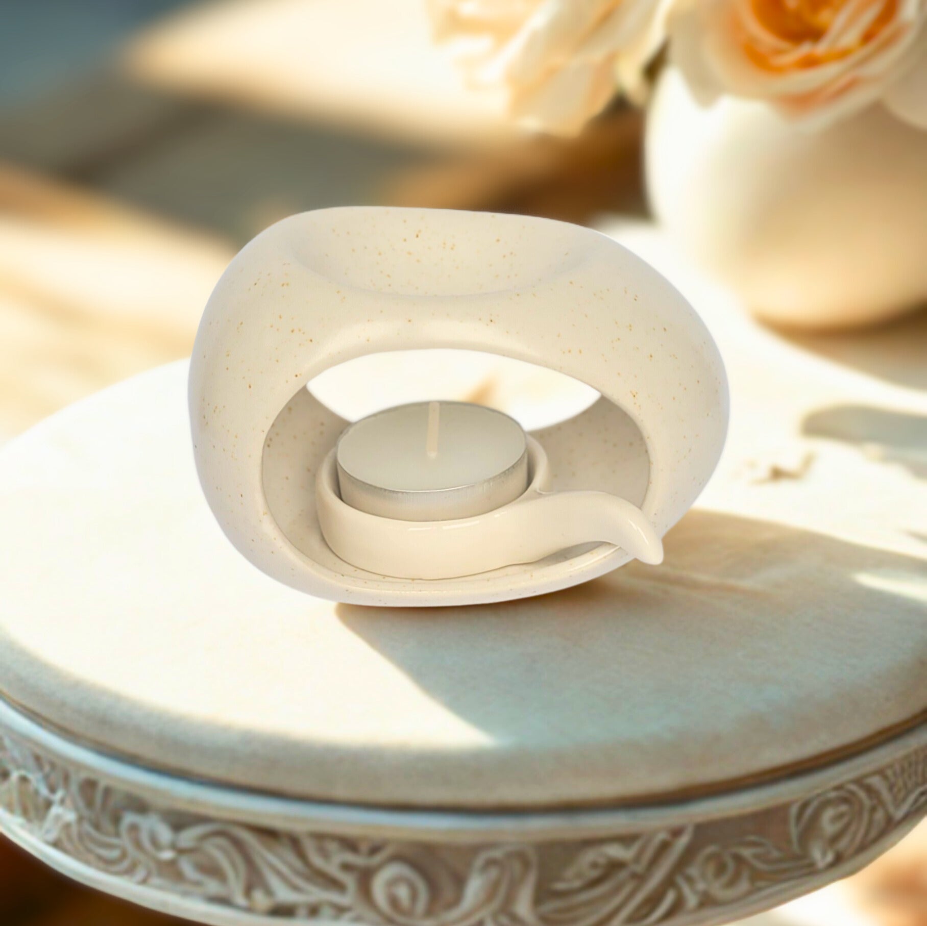 Decorative candle holder with a candle on a textured surface