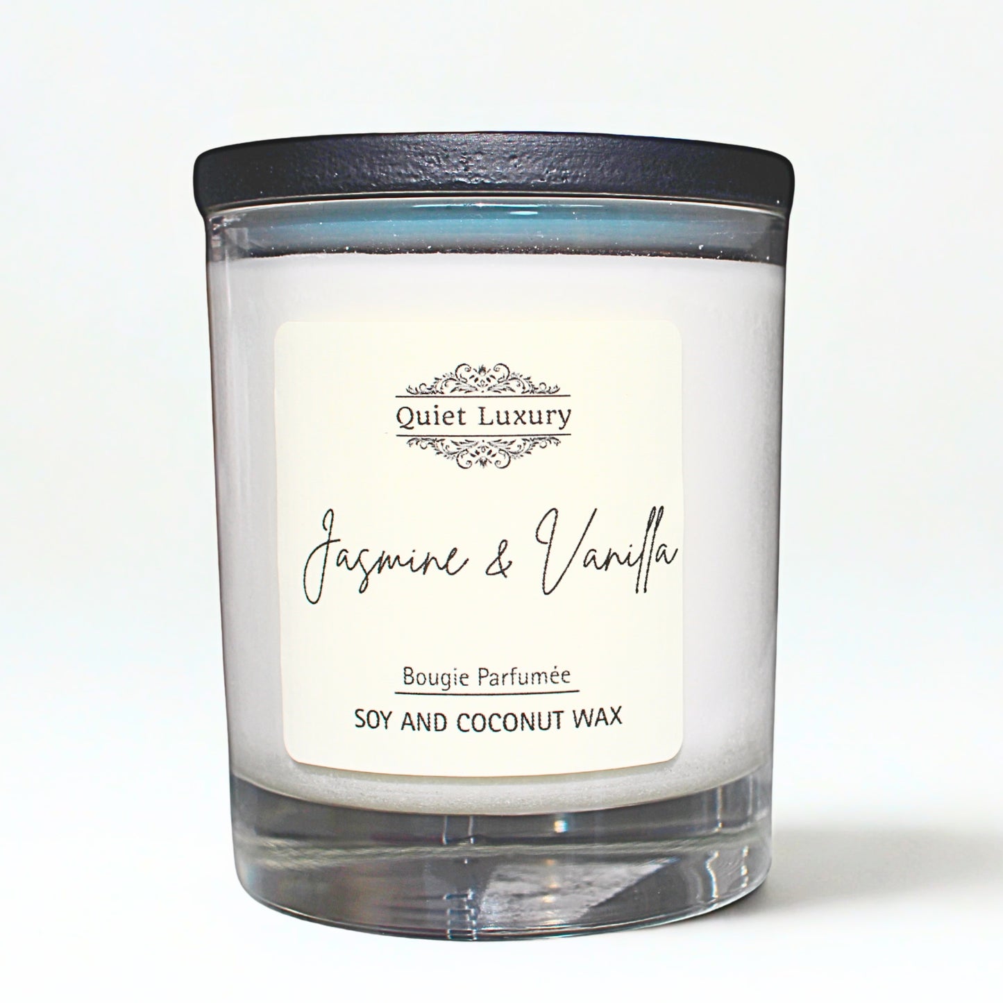 Candle with a label reading 'Jasmine & Vanilla' on a white background