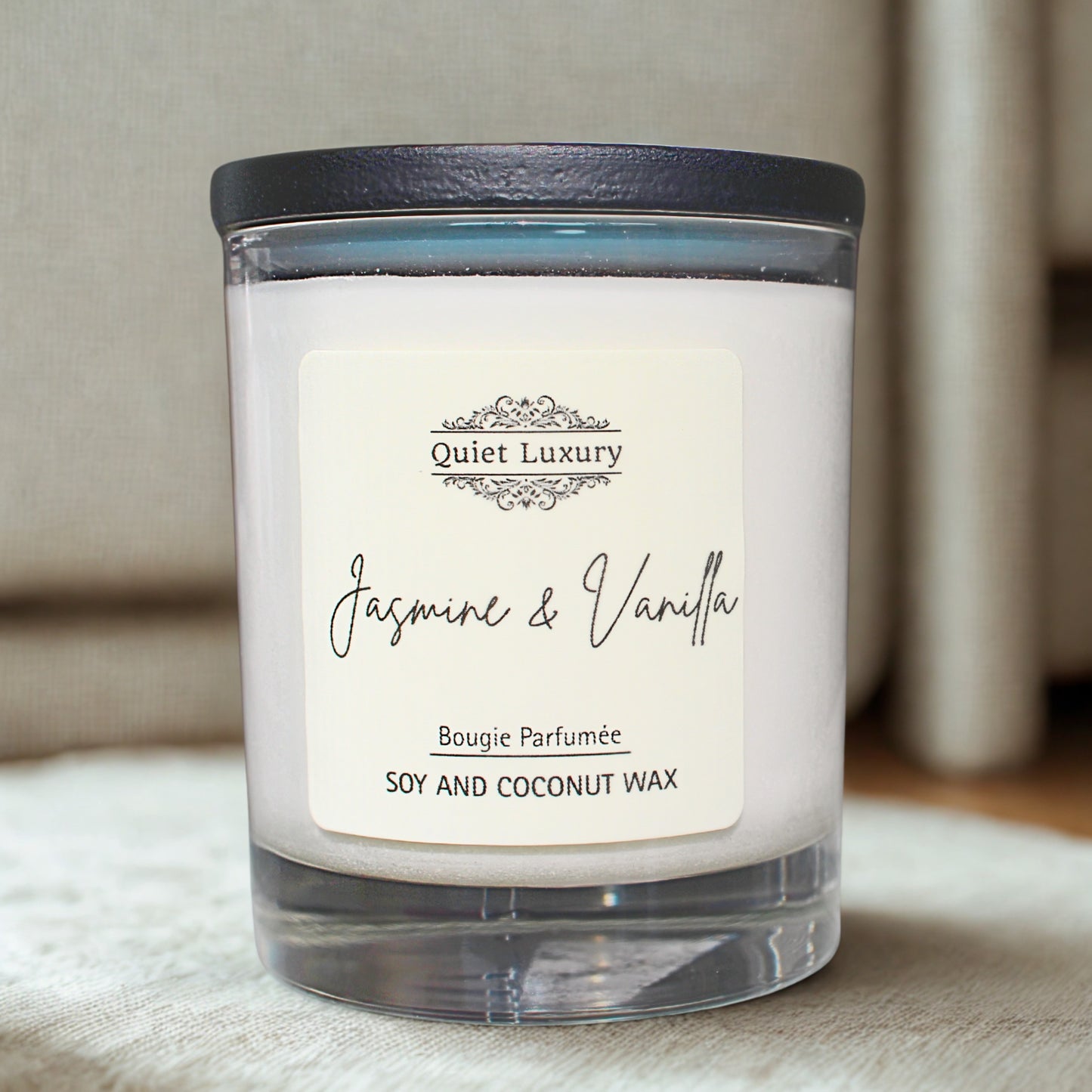 jasmine and vanilla Candle with 'Quiet Luxury' label on a soft surface