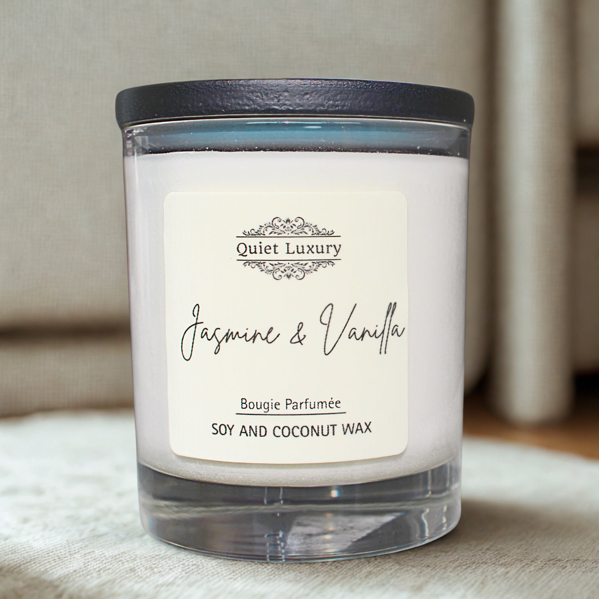 jasmine and vanilla Candle with 'Quiet Luxury' label on a soft surface