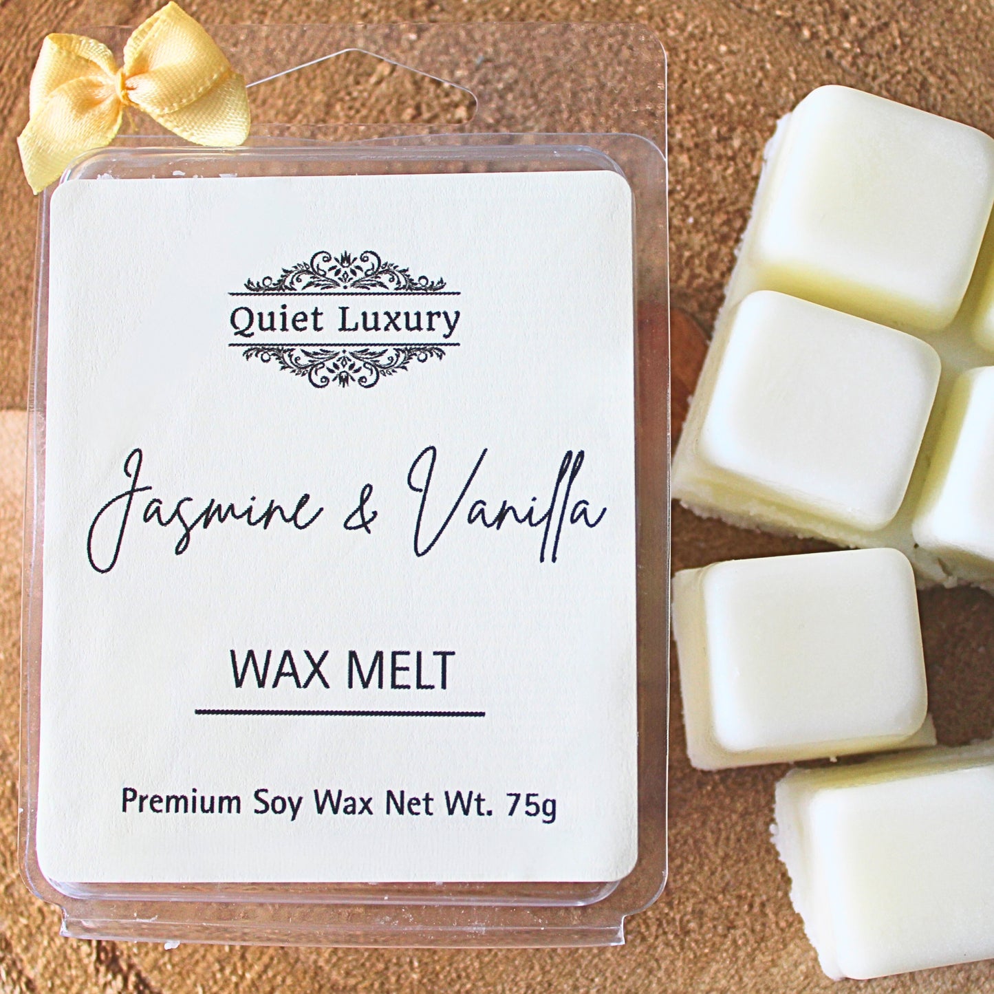 Packaged jasmine and vanilla wax melts with 'Quiet Luxury' branding and jasmine & vanilla scent on a wooden surface.