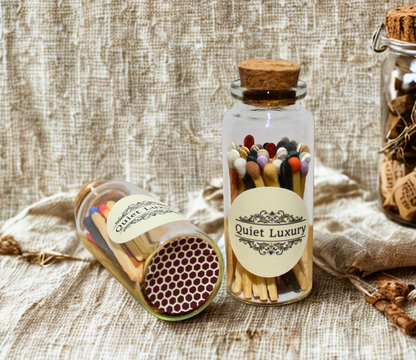 Luxury match jars with multicolored matches and cork lids on rustic fabric background
