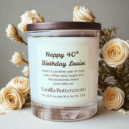 Personalised vanilla buttercream candle with custom birthday label, surrounded by cream flowers