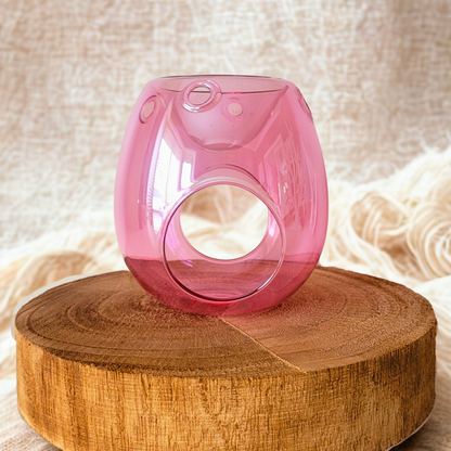 Pink wax warmer with glossy finish on wooden stand, perfect for home fragrance.