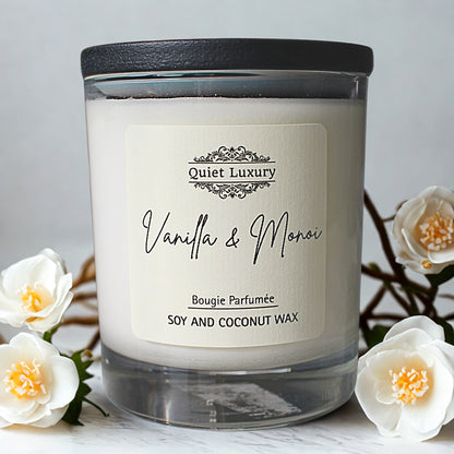 Vanilla and Monoi scented soy and coconut wax candle in glass jar with white flowers