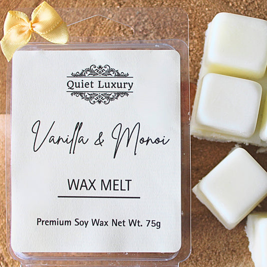 Quiet Luxury Vanilla & Monoi wax melt packaging with wax melts on a wooden surface.