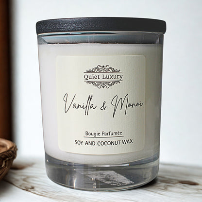 Vanilla and Monoi soy and coconut wax candle in clear glass jar with black lid
