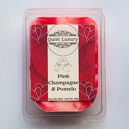 Pink Champagne & Pomelo soy wax melt in packaging with Quiet Luxury label on a light gray background