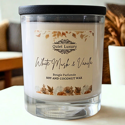 Candle with 'Quiet Luxury' label on a blurred indoor background white musk and vanilla