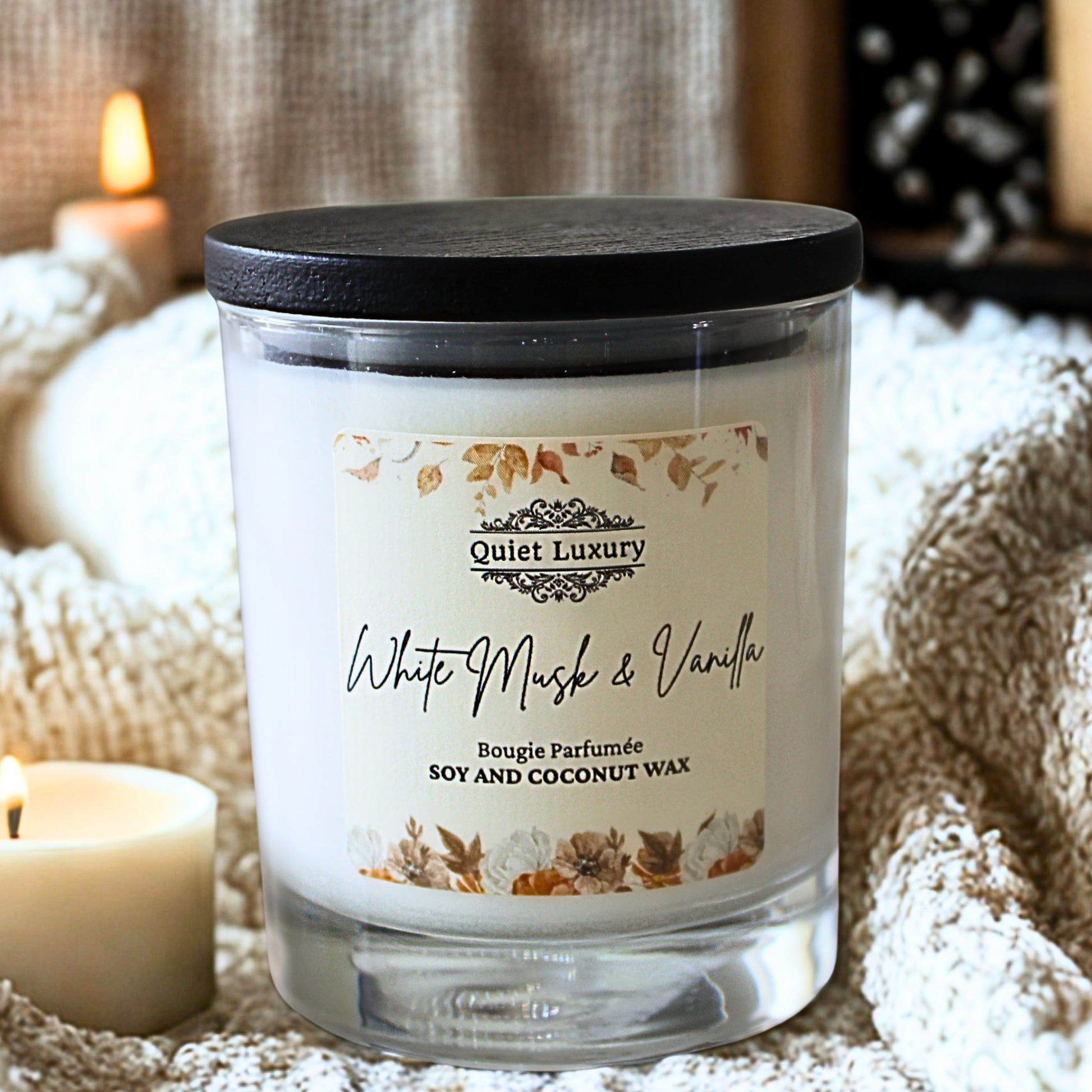Candle with 'Quiet Luxury' label in a cozy setting white musk and vanilla